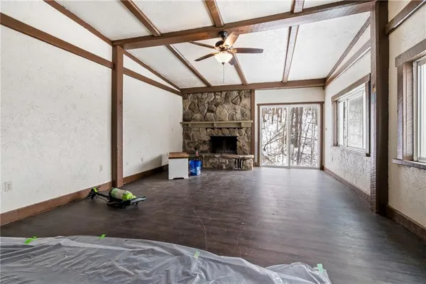 a view of a livingroom with furniture hardwood floor and a ceiling fan