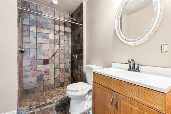 a bathroom with a sink a toilet and shower