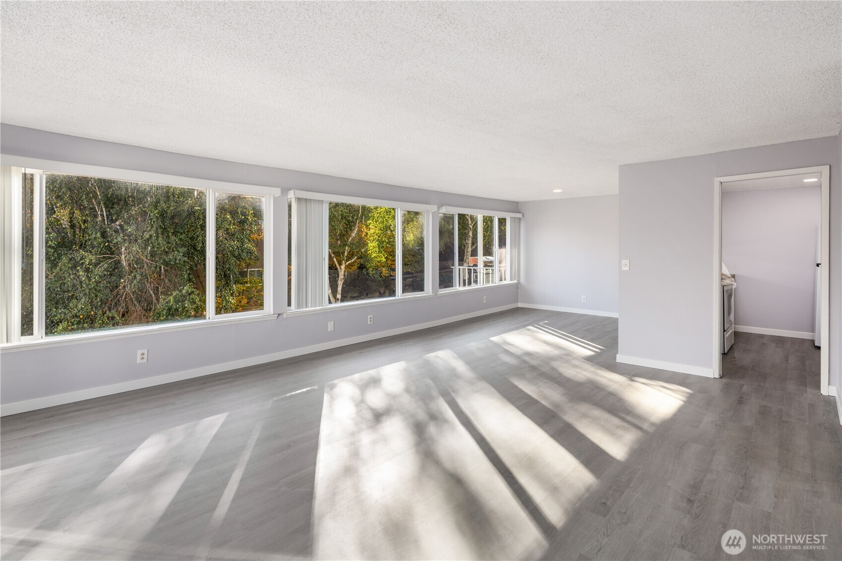 3600 25th Avenue West Seattle, WA 98199 - Photo 16 of 30 a view of an empty room with wooden floor and a window
