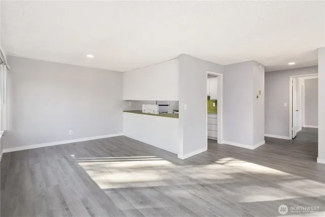 a view of empty room with wooden floor