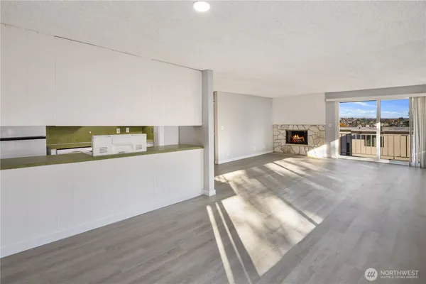 a view of a kitchen with wooden cabinet and a stove