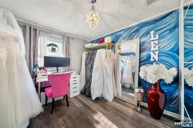 a view of a room with furniture and wooden floor