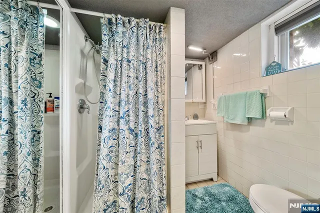 a bathroom with a shower curtain and a toilet