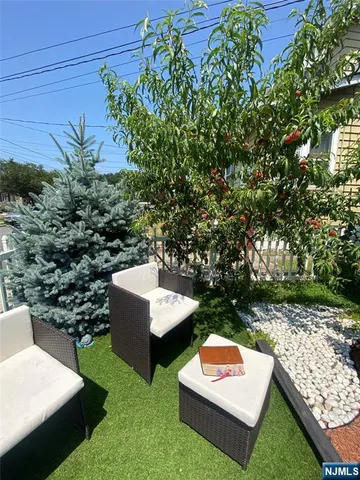 a view of a two chairs and table in a yard