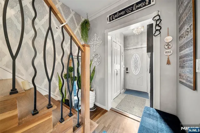 a view of an entryway with wooden floor and a livingroom