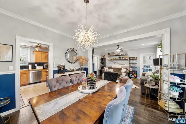 a living room with fireplace furniture and a chandelier
