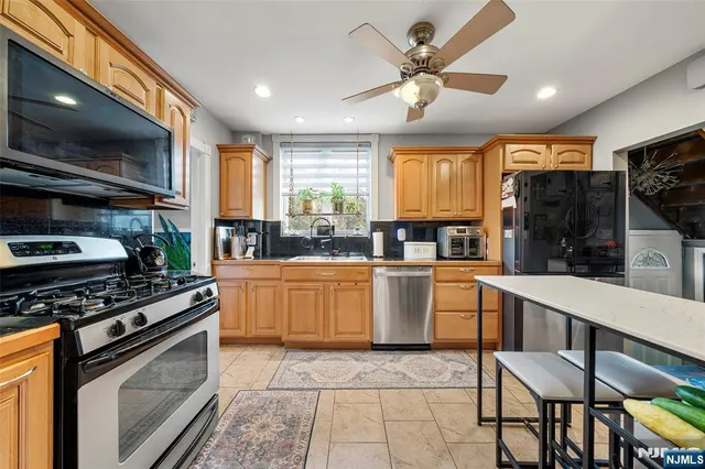 a kitchen with a stove a sink and a microwave