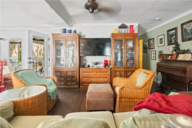 a living room with furniture a flat screen tv and a floor to ceiling window