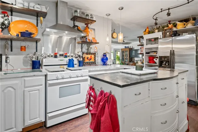a kitchen with stainless steel appliances granite countertop a sink and cabinets