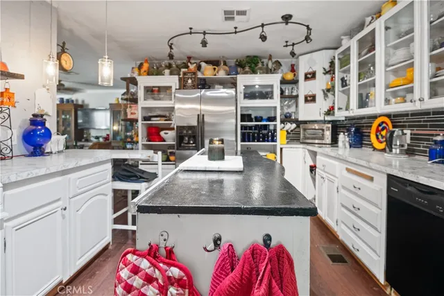 a view of kitchen cabinets and wooden floor