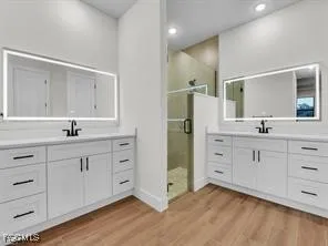 a spacious bathroom with double sink and a mirror