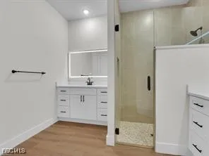a bathroom with a shower sink and mirror