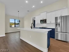 a kitchen with stainless steel appliances a refrigerator sink and microwave