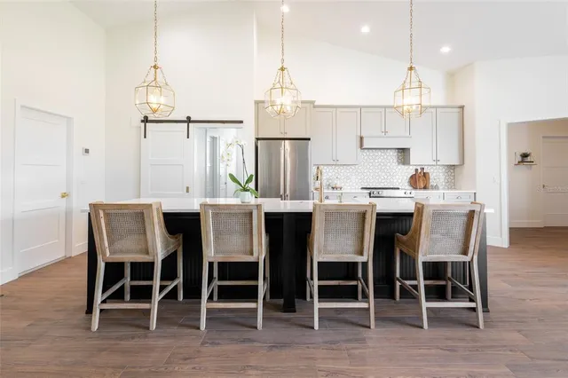 a dining room with furniture a chandelier and wooden floor