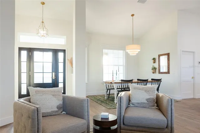 a living room with furniture a window and a chandelier