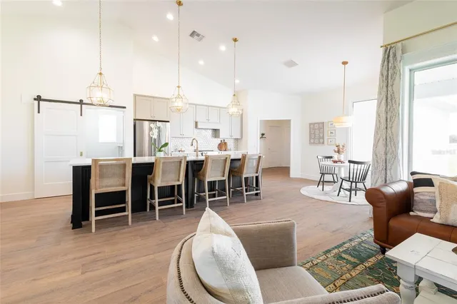 a large kitchen with a table and chairs