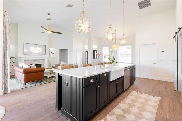 a large kitchen with kitchen island granite countertop a sink and a stove