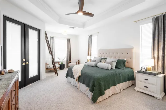 a living room with a bed furniture and a large window