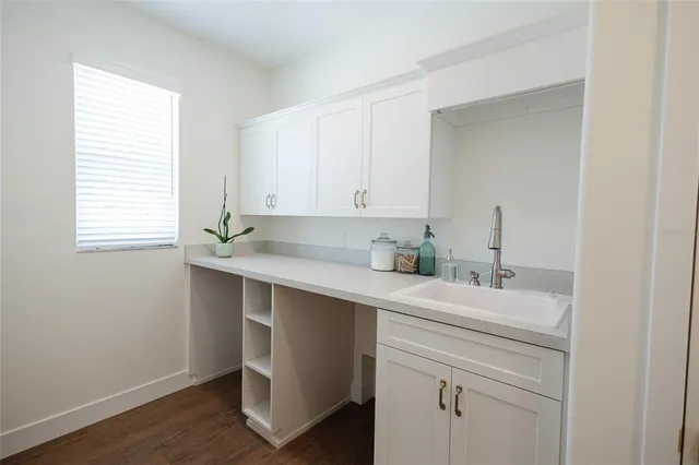 a view of a room with wooden floor and cabinet