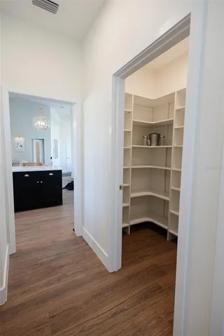 a view of a big room with windows and chandelier