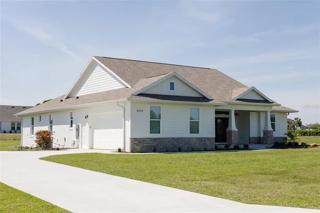 a front view of a house with a garden and plants