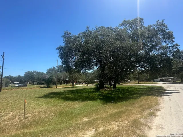 a view of outdoor space with green field and trees