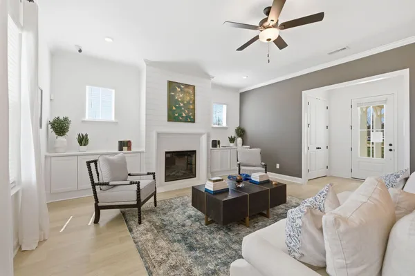 a living room with furniture a fireplace and a table
