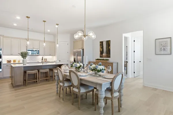 a large kitchen with a table and chairs