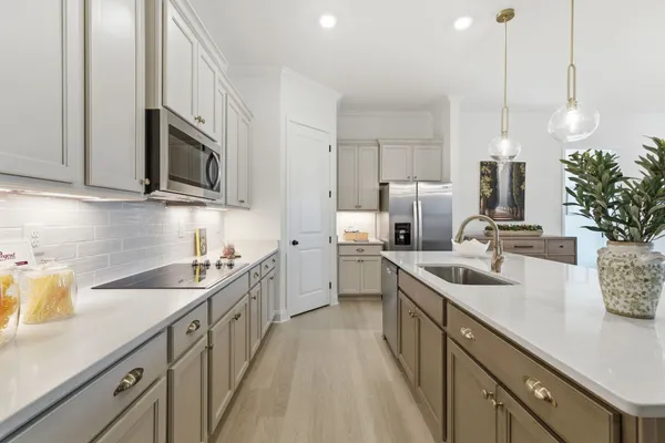 a kitchen with sink cabinets and microwave