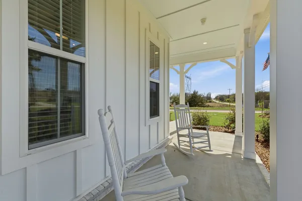 a balcony with table and chairs