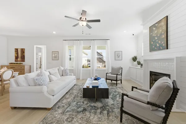 a living room with furniture and a chandelier