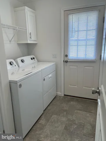a view of storage and utility room with washer and dryer