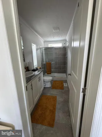 a bathroom with a sink a toilet a shower a mirror and a tub
