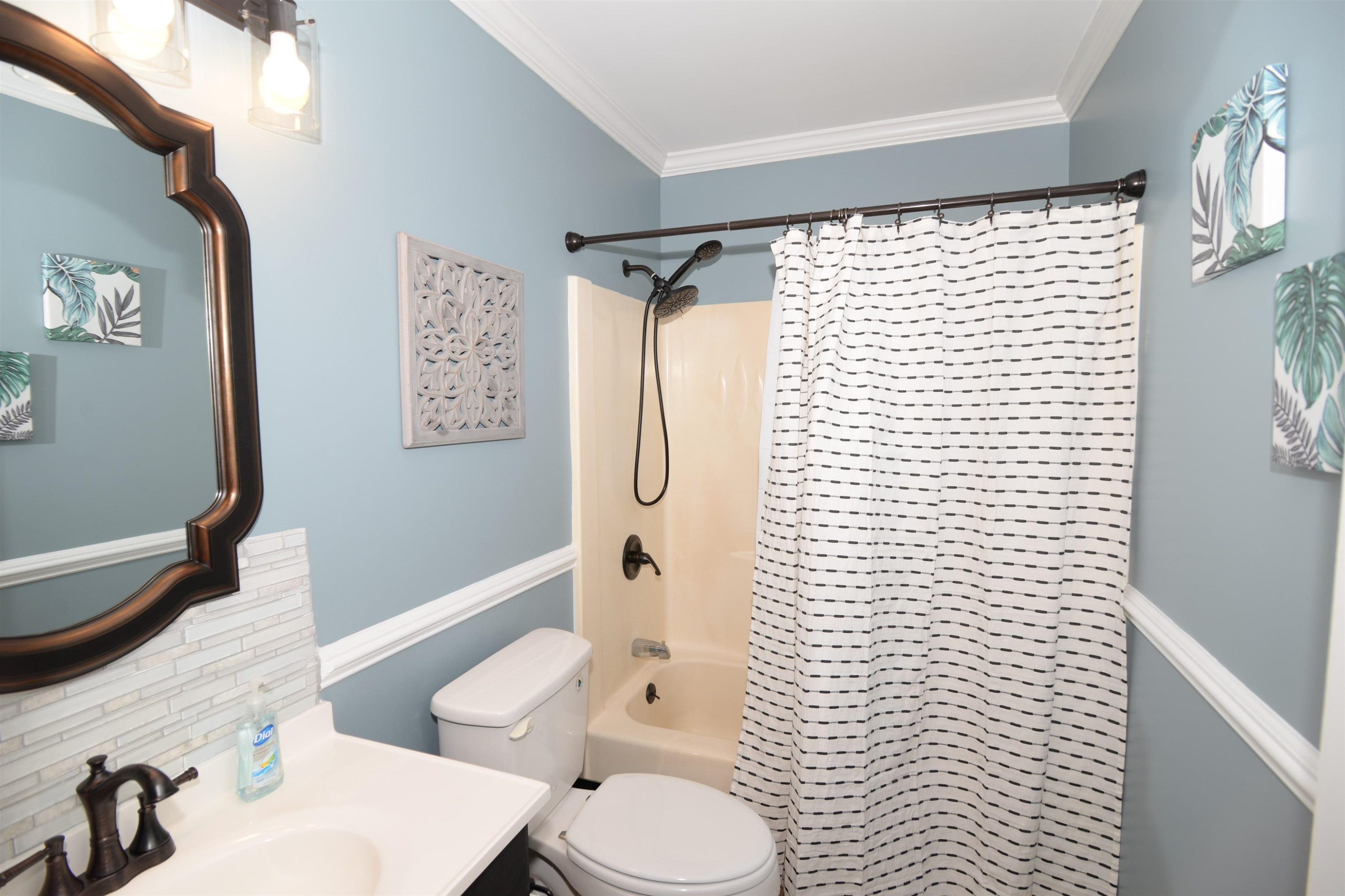 1023 Legend Road Raleigh, NC 27603 - Photo 16 of 30 Freestanding vanity and a combination shower/tub make this a comfortable ensuite. Chair rail, crown molding and custom fixtures make it a stylish one too! Master Bathroom