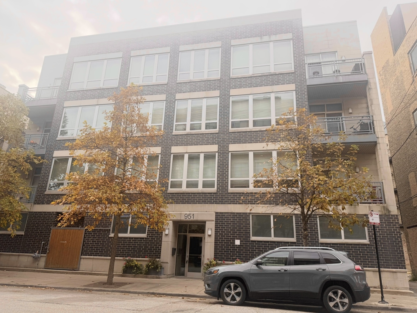 951 West Huron Street, Unit 402 Chicago, IL 60642 - Photo 1 of 18 a front view of a building with a parking space