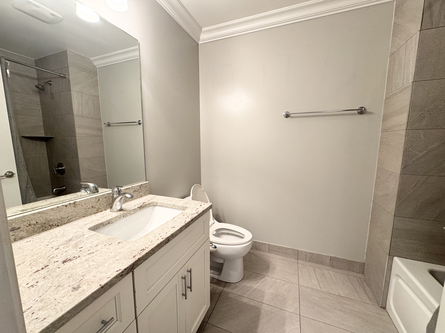 951 West Huron Street, Unit 402 Chicago, IL 60642 - Photo 16 of 18 a bathroom with a granite countertop sink toilet and shower