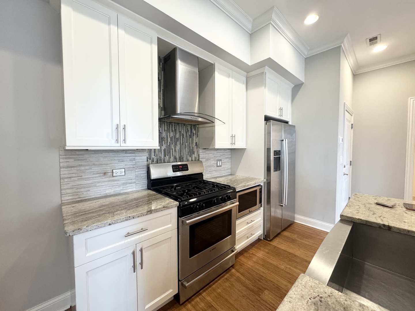 951 West Huron Street, Unit 402 Chicago, IL 60642 - Photo 3 of 18 a kitchen with stainless steel appliances granite countertop a stove a refrigerator and a cabinets