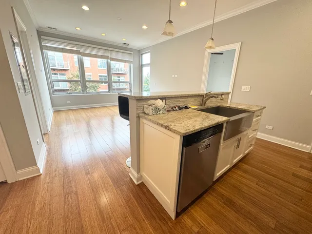 a kitchen with a wooden floor and large window