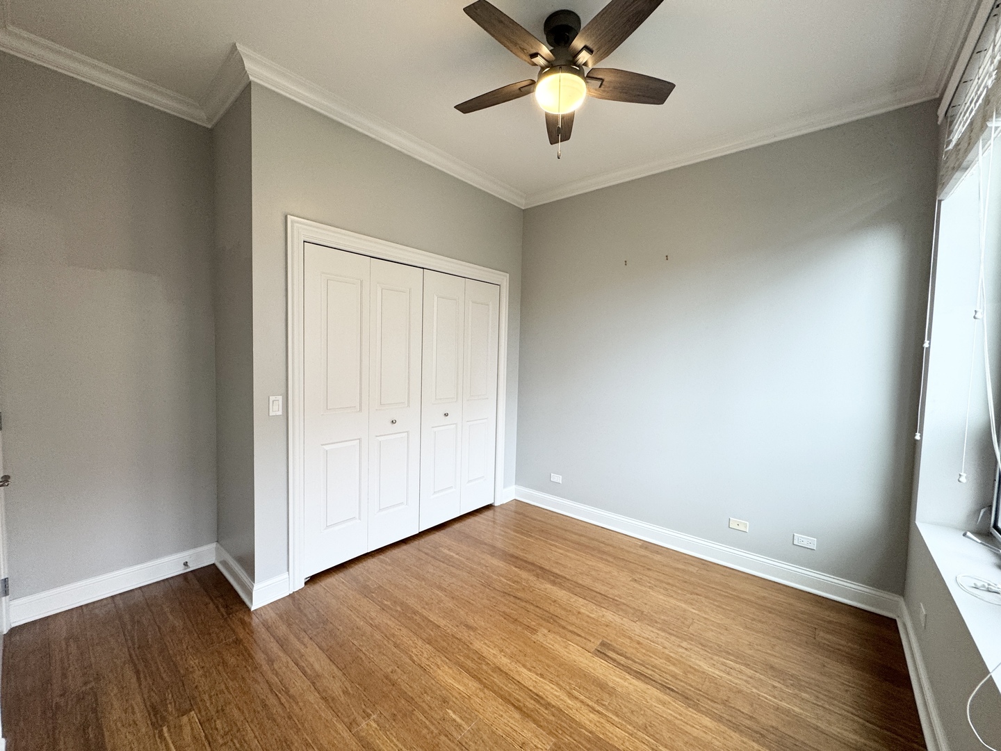 951 West Huron Street, Unit 402 Chicago, IL 60642 - Photo 9 of 18 an empty room with wooden floor and windows