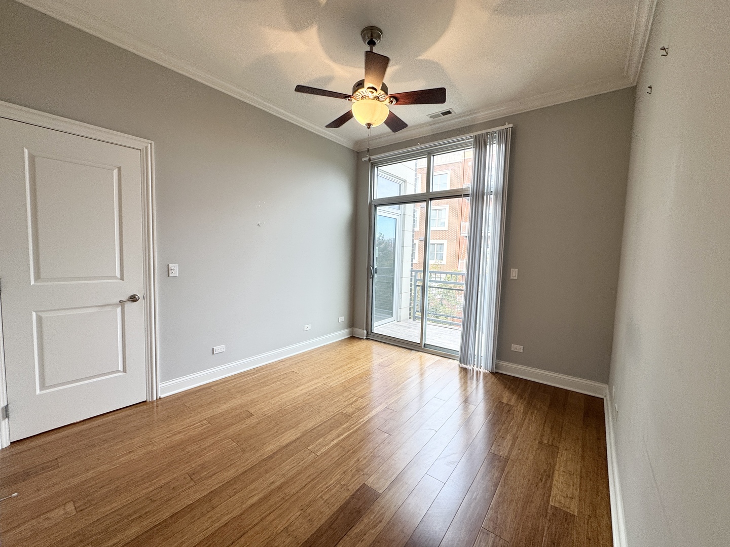 951 West Huron Street, Unit 402 Chicago, IL 60642 - Photo 10 of 18 a view of an empty room with wooden floor and a window