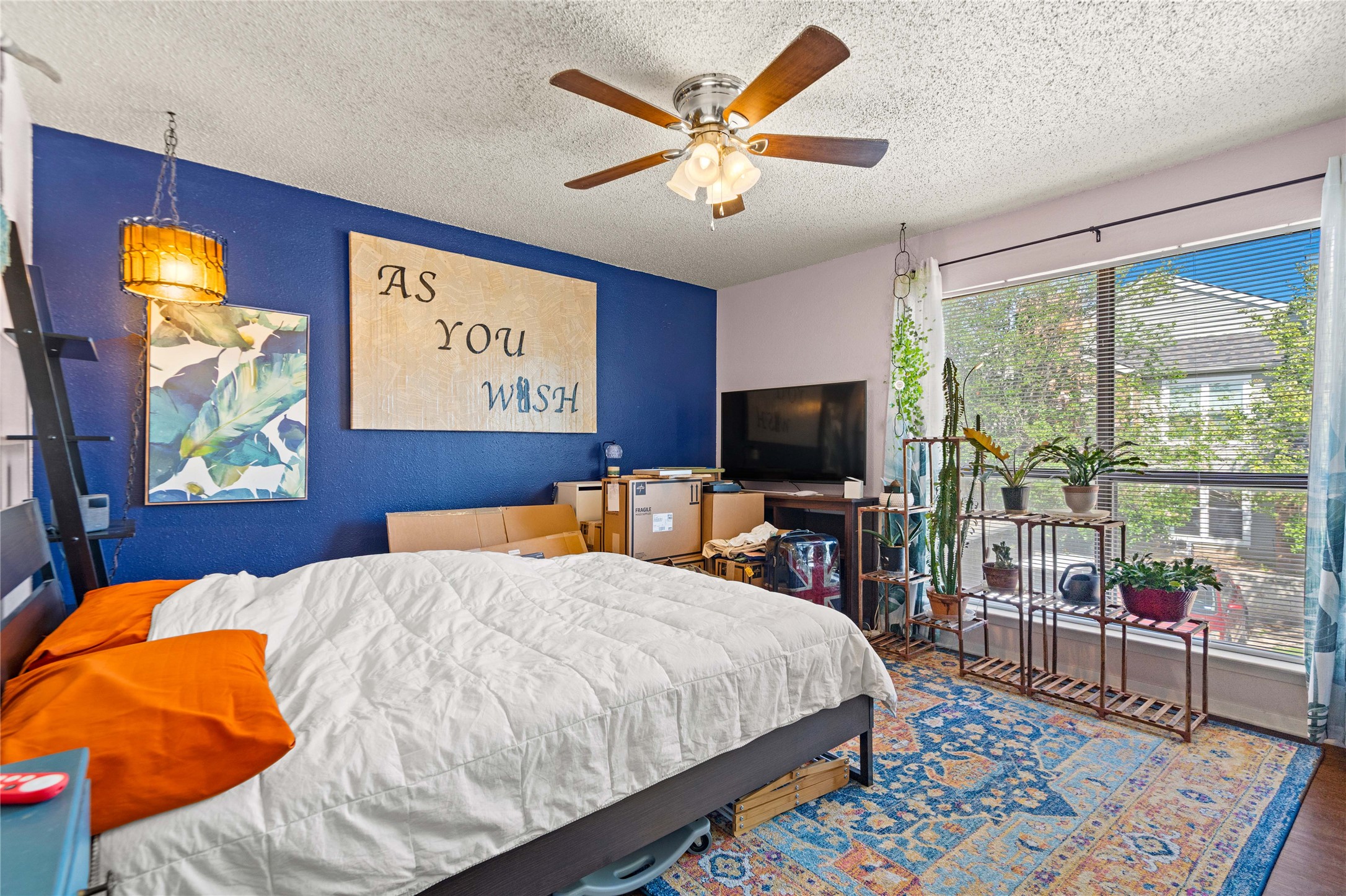 2018 West Rundberg Lane, Unit 4B Austin, TX 78758 - Photo 16 of 28 a bed room with a bed a television and a large window