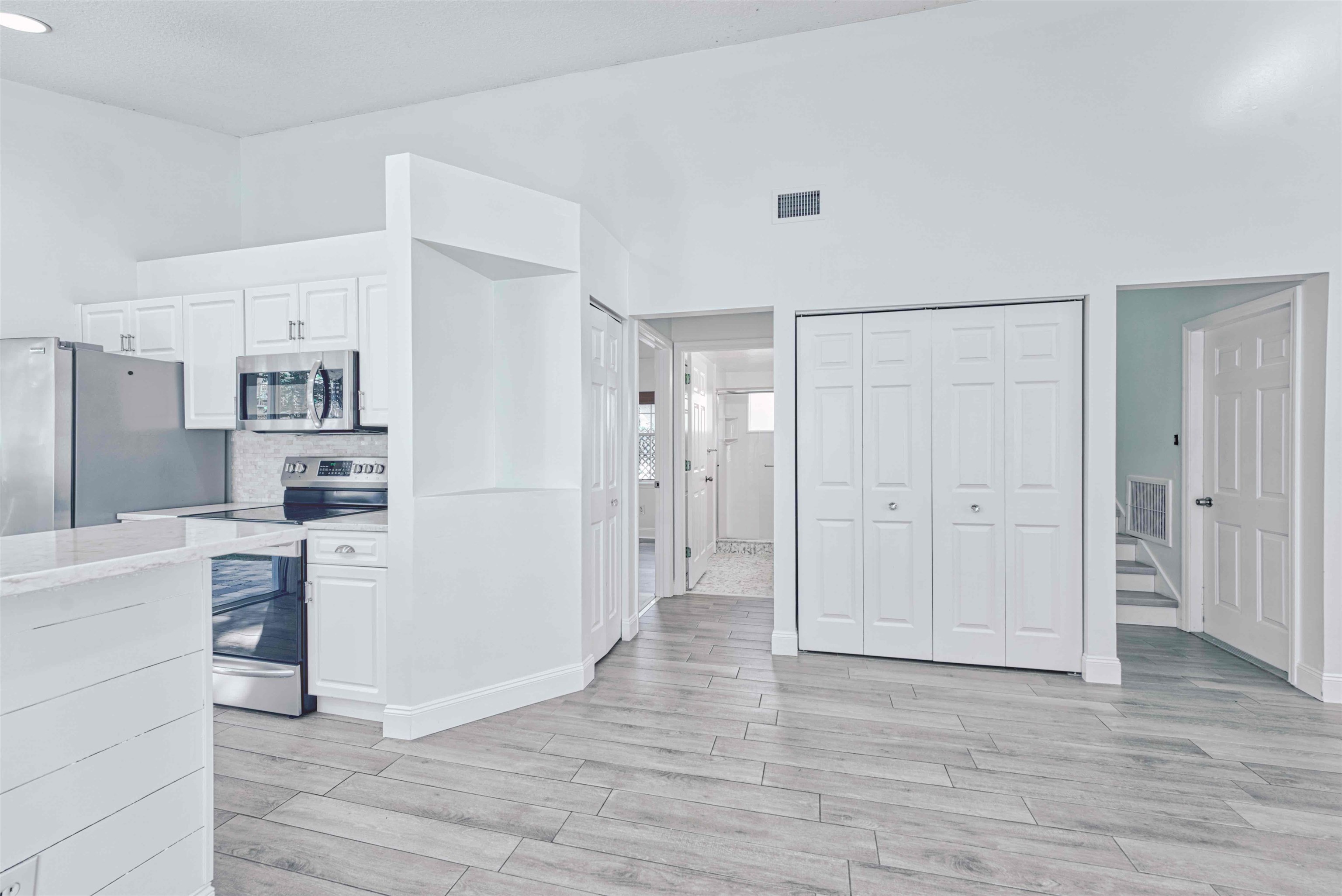 303 D Street St. Augustine, FL 32080 - Photo 12 of 35 a view of a kitchen with refrigerator and wooden floor