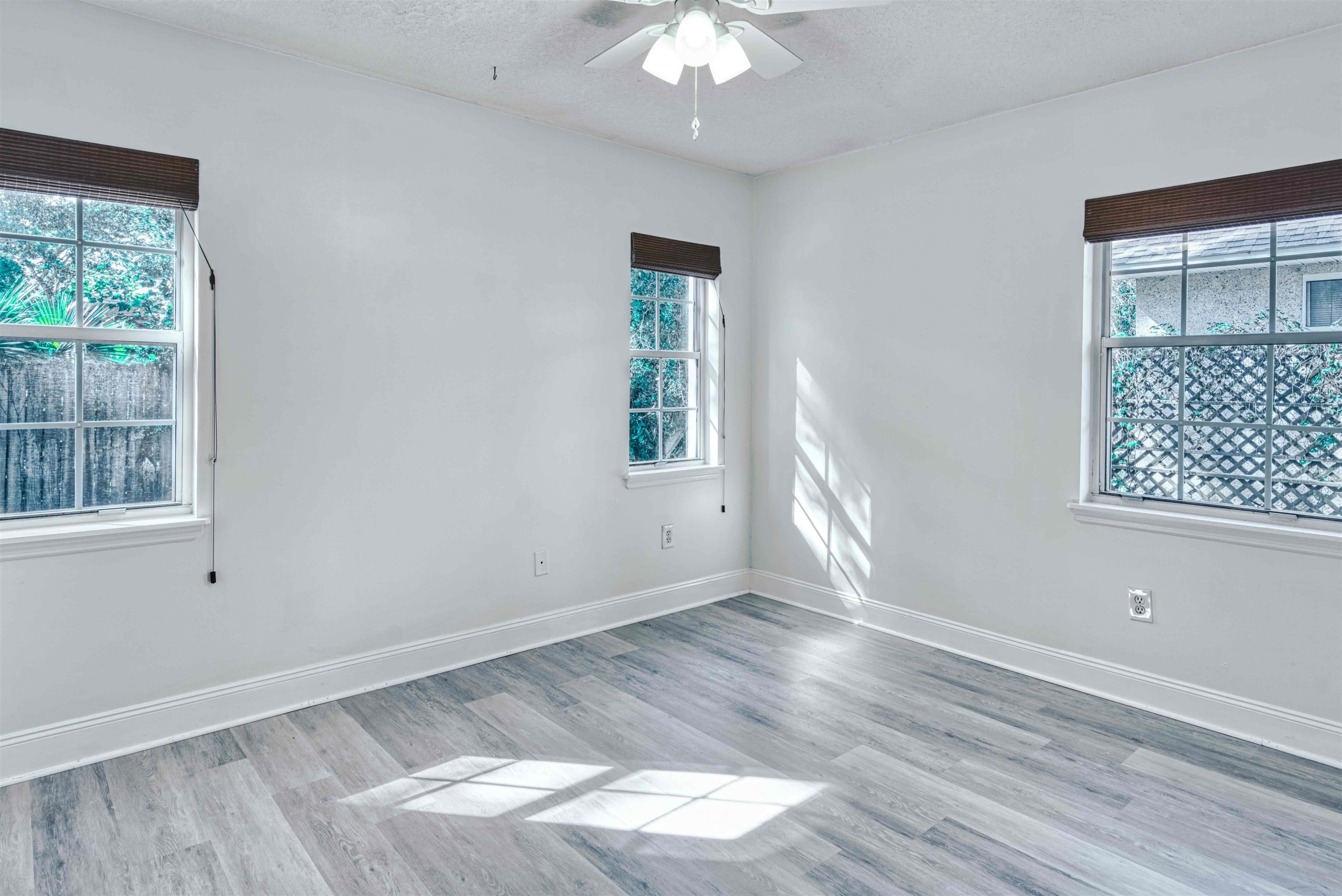 303 D Street St. Augustine, FL 32080 - Photo 19 of 35 a view of an empty room with wooden floor and a window