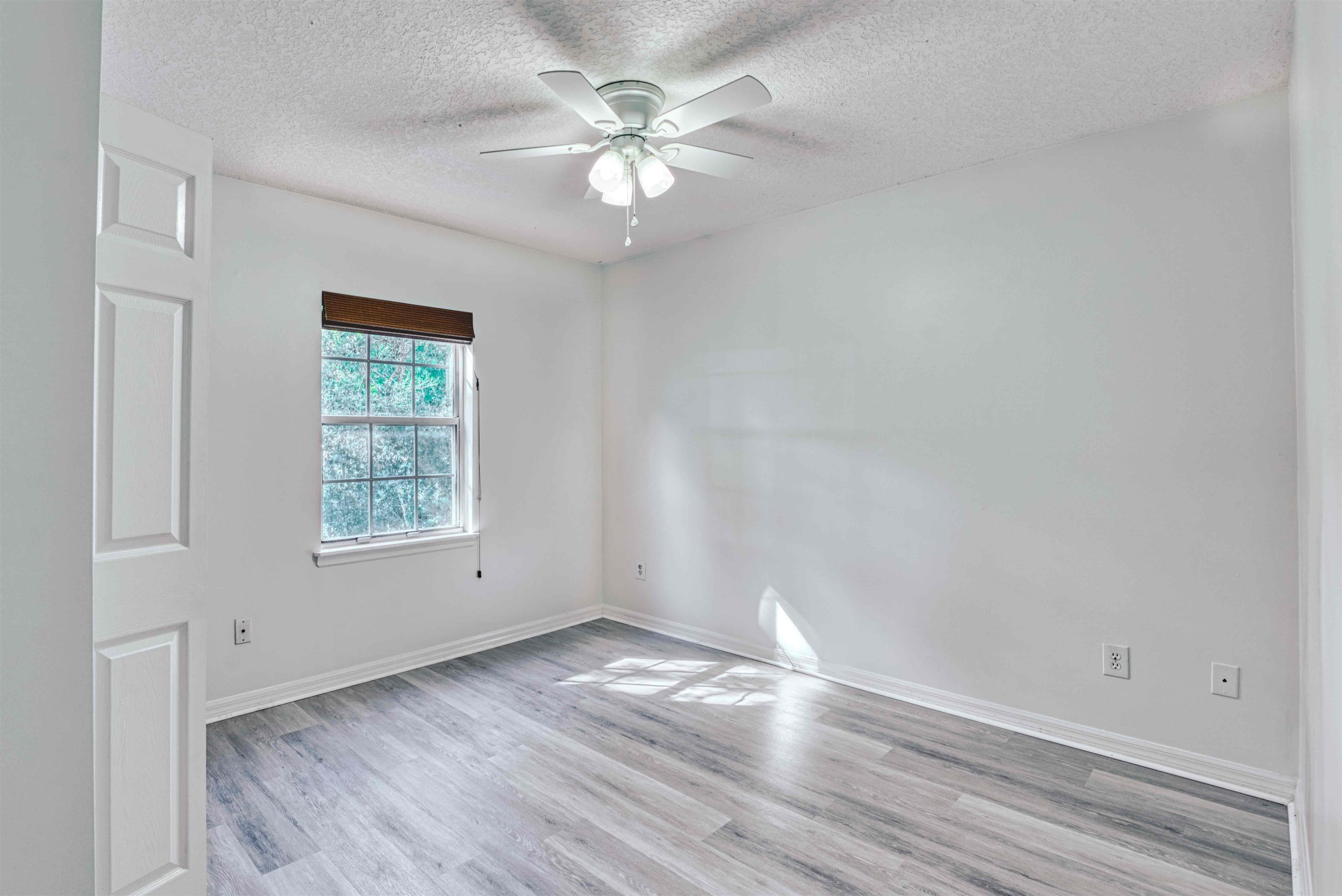 303 D Street St. Augustine, FL 32080 - Photo 24 of 35 an empty room with wooden floor and windows