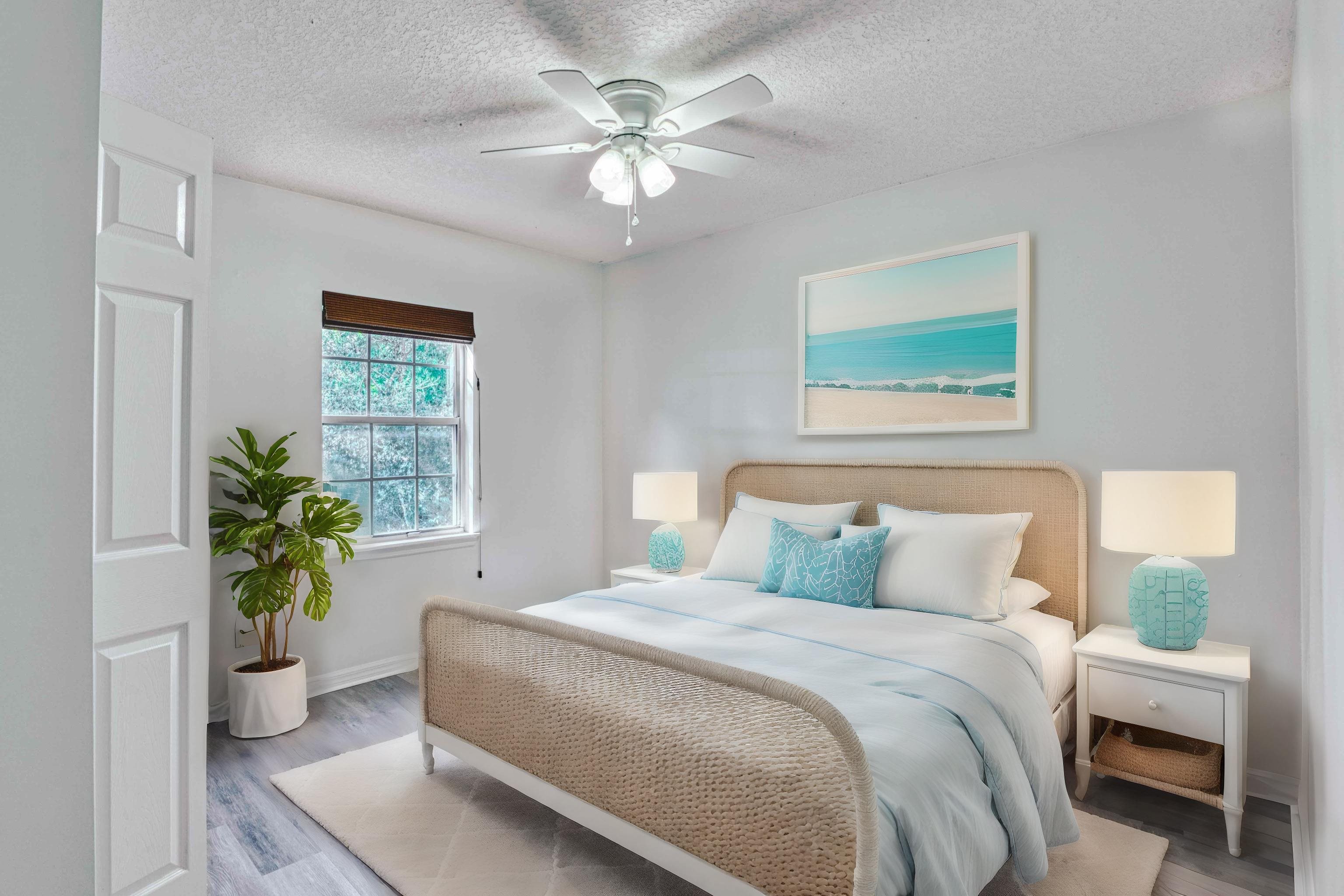 303 D Street St. Augustine, FL 32080 - Photo 25 of 35 a bedroom with a bed and a chandelier