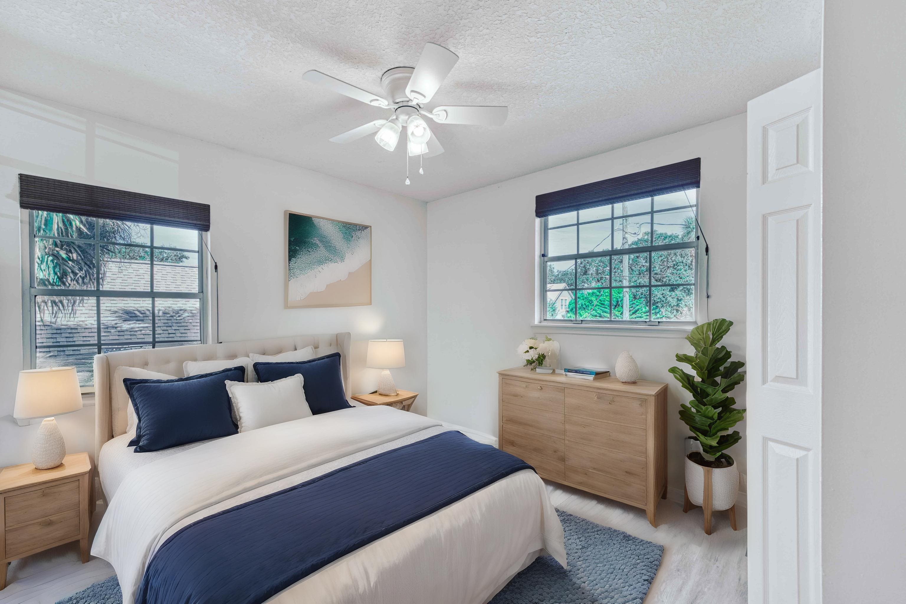 303 D Street St. Augustine, FL 32080 - Photo 28 of 35 a bedroom with a large bed and a potted plant