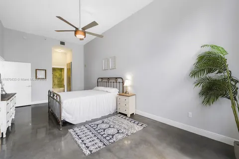 a living room with a couch and a potted plant