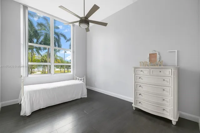 a room with a baby bed baby crib and a dresser