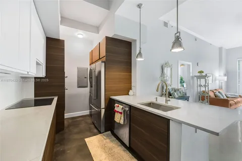 a kitchen with stainless steel appliances a sink stove and refrigerator