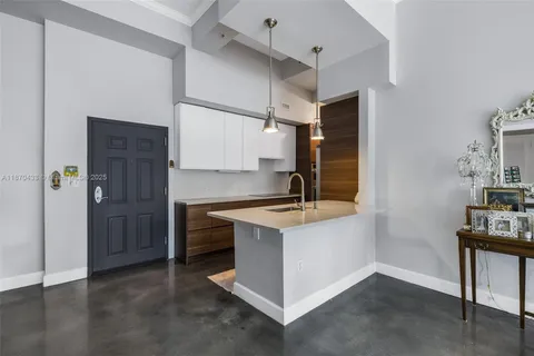 a kitchen with stainless steel appliances a sink stove and refrigerator